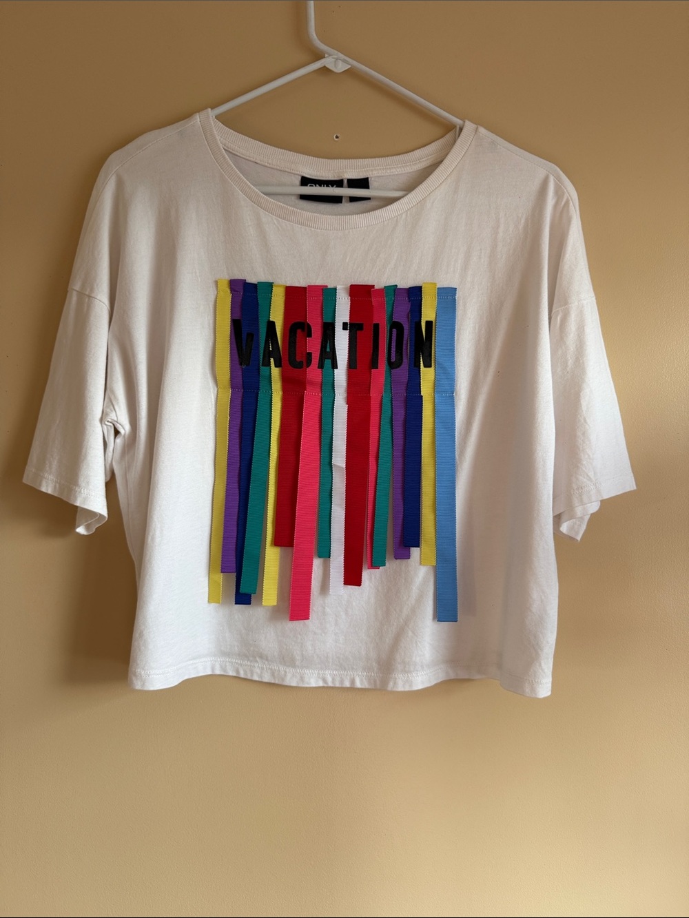 Only White Tee with Multicolor Ribbon Fringe and 'VACATION' Text